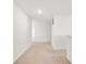 Well-lit hallway with neutral carpet leads to other areas of the home at 7517 Heben Dr, Indianapolis, IN 46113