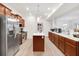 Spacious kitchen with stainless steel appliances, island with white countertops, and ample cabinet space at 7517 Heben Dr, Indianapolis, IN 46113