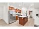 Modern kitchen featuring stainless steel refrigerator and island with marble countertops at 7517 Heben Dr, Indianapolis, IN 46113