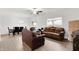 Spacious living room with hardwood floors adjacent to a dining area and lots of natural light at 7517 Heben Dr, Indianapolis, IN 46113