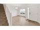 Bright living area with hardwood floors, a hanging light fixture, and a staircase at 7517 Heben Dr, Indianapolis, IN 46113