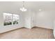 Bright living area with hardwood floors, a hanging light fixture, and a large window at 7517 Heben Dr, Indianapolis, IN 46113