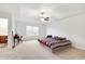 Spacious main bedroom featuring soft carpet, a ceiling fan and ensuite bathroom access at 7517 Heben Dr, Indianapolis, IN 46113