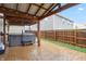 Outdoor living space with a hot tub, wooden posts, stamped concrete flooring, and a fenced-in yard at 7517 Heben Dr, Indianapolis, IN 46113