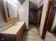 Bathroom with vanity, mirrors, and wood-look flooring at 791 W 500 S, Greenfield, IN 46140