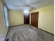 Bedroom featuring neutral carpet, a ceiling fan, and a double-door closet at 791 W 500 S, Greenfield, IN 46140