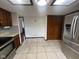 Well-lit kitchen with stainless appliances, tile floors and an adjacent closet, blending functionality with style at 791 W 500 S, Greenfield, IN 46140