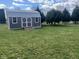 Backyard features a well-maintained shed on a grassy lawn, adding storage and functionality to the property at 791 W 500 S, Greenfield, IN 46140