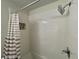 Bright bathroom featuring a shower-tub combo and decorative mosaic tile accent at 8525 E 42Nd Pl, Indianapolis, IN 46226