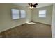 Cozy bedroom featuring neutral carpet, ceiling fan, and natural light from multiple windows at 8525 E 42Nd Pl, Indianapolis, IN 46226