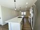 Open-concept kitchen showcasing the island, stainless steel appliances, and modern pendant lighting at 8525 E 42Nd Pl, Indianapolis, IN 46226