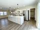 Spacious kitchen boasts an island with modern lighting, ample storage, and stainless steel appliances at 8525 E 42Nd Pl, Indianapolis, IN 46226
