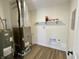 Functional utility room featuring modern water heater, furnace, and shelving storage at 8525 E 42Nd Pl, Indianapolis, IN 46226
