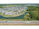 An aerial view of a community with a pond and lush green landscape on a sunny day at 9723 Violet Cir, Indianapolis, IN 46239
