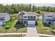 Aerial shot of a home with landscaped yard, a backyard pond, and neighboring properties, highlighting the community at 9723 Violet Cir, Indianapolis, IN 46239