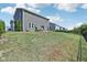 Expansive backyard featuring a well-maintained lawn, patio, and landscaped area with a view of neighboring homes at 9723 Violet Cir, Indianapolis, IN 46239