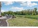 Scenic backyard with a view of the water, patio seating, and lush greenery, perfect for relaxing outdoors at 9723 Violet Cir, Indianapolis, IN 46239