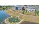Grey two-story home with a fenced yard, patio with seating, and pond views at 9723 Violet Cir, Indianapolis, IN 46239