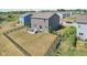 A fenced backyard with patio and firepit next to a two-story home at 9723 Violet Cir, Indianapolis, IN 46239
