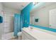 Bright bathroom featuring modern sink, vanity, and mirror, combined with a shower-tub combo with curtain at 9723 Violet Cir, Indianapolis, IN 46239