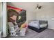 Bright bedroom featuring a unique mural and fan, with comfortable carpeted floors, and a rocking chair at 9723 Violet Cir, Indianapolis, IN 46239