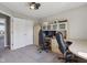Comfortable bedroom with carpeted floors and fan; set up with desk and chair, as well as built-in storage at 9723 Violet Cir, Indianapolis, IN 46239