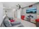 Spacious upstairs entertainment room offers a cozy couch, ceiling fan and mounted television at 9723 Violet Cir, Indianapolis, IN 46239