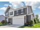 Attractive two-story home with a combination of brick and gray siding, offering a two car garage and landscaped front yard at 9723 Violet Cir, Indianapolis, IN 46239