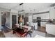 Modern kitchen and dining space featuring stylish lighting, white cabinets, and a dining table with a rustic bench at 9723 Violet Cir, Indianapolis, IN 46239