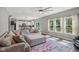 Open-concept living room connected to the kitchen, featuring a large sectional sofa, ample windows, and stylish decor at 9723 Violet Cir, Indianapolis, IN 46239