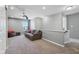 Upstairs living area has neutral walls, carpet and plenty of comfortable seating and natural light at 9723 Violet Cir, Indianapolis, IN 46239