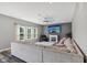Bright living room with a fireplace, a large comfortable sectional sofa, and three large windows allowing natural light at 9723 Violet Cir, Indianapolis, IN 46239