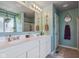 The main bathroom offers a dual sink vanity and a view to the shower and the toilet at 9723 Violet Cir, Indianapolis, IN 46239
