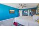 Stylish main bedroom with blue walls, ceiling fan, and modern barn door leading to the bathroom at 9723 Violet Cir, Indianapolis, IN 46239