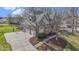Aerial view of a brick home with a 3 car garage, basketball hoop, and lush landscaping at 9931 Woodlands Dr, Fishers, IN 46037