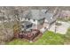 Aerial view of the home featuring a backyard with deck, hot tub, patio, and attached garage at 9931 Woodlands Dr, Fishers, IN 46037