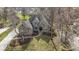 Brick home with large driveway, manicured lawn and garden beds from above at 9931 Woodlands Dr, Fishers, IN 46037