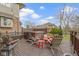 Entertain or unwind on this spacious wooden deck with a hot tub, chairs and red accent tables at 9931 Woodlands Dr, Fishers, IN 46037