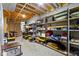 Unfinished basement with concrete floor, open ceiling, and lots of shelving storage space at 9931 Woodlands Dr, Fishers, IN 46037