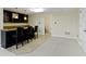 Basement wet bar complete with dark cabinets, granite counters, and seating at 9931 Woodlands Dr, Fishers, IN 46037
