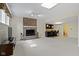Finished basement area showcasing a brick fireplace, bar with seating, and plush carpeting at 9931 Woodlands Dr, Fishers, IN 46037