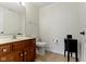 Half bathroom with updated vanity, neutral wall color, and tiled flooring at 9931 Woodlands Dr, Fishers, IN 46037