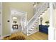 Spacious foyer with stairs, light hardwood floors, and an entryway into the living room at 9931 Woodlands Dr, Fishers, IN 46037