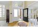 Grand foyer featuring a high ceiling, decorative window, and hardwood floors at 9931 Woodlands Dr, Fishers, IN 46037