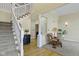 Bright foyer area with staircase and stylish decor with access to the living room at 9931 Woodlands Dr, Fishers, IN 46037