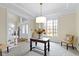 Inviting foyer with neutral colors, a statement table with floral decor, and ample natural light from a large window at 9931 Woodlands Dr, Fishers, IN 46037