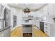 Contemporary kitchen featuring stainless steel appliances, an island, and ample storage with bright white cabinetry at 9931 Woodlands Dr, Fishers, IN 46037