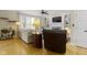 Bright living room with hardwood floors, a fireplace, and built-in shelving at 9931 Woodlands Dr, Fishers, IN 46037