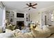 Comfortable living room with hardwood floors, a ceiling fan, and a fireplace at 9931 Woodlands Dr, Fishers, IN 46037