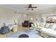 Bright and airy living room showcases hardwood floors, a ceiling fan, and a light-filled ambiance with comfortable seating at 9931 Woodlands Dr, Fishers, IN 46037